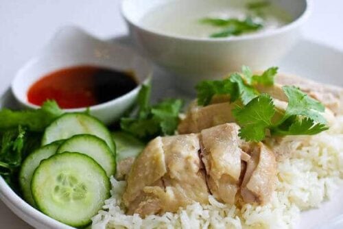 Hainanese chicken and rice on a white plate