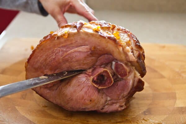 cutting through cooked ham