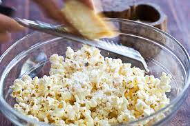 Grating cheese onto your popcorn