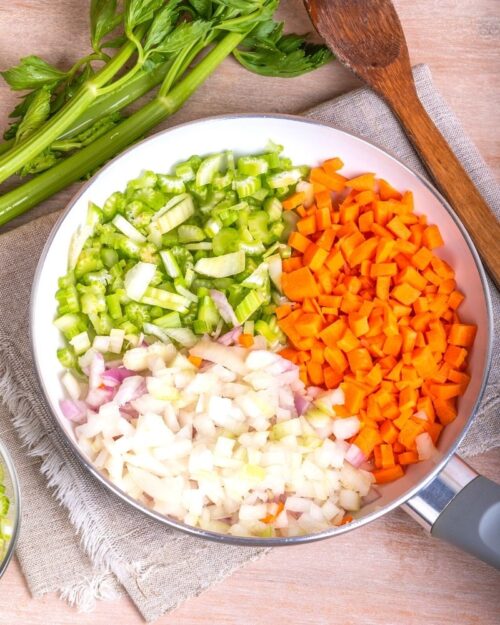 Mirepoix of celery, carrots, and onions in a satué pan. 