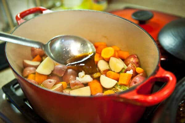 pouring sauce on veg