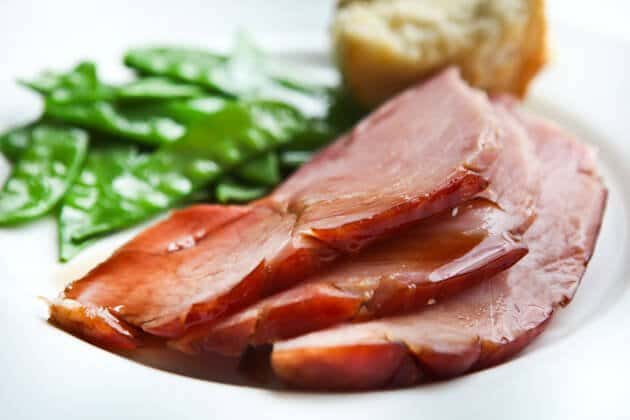 glazed ham recipe on plate with peas