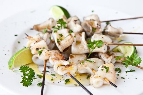 Grilled Calamari skewers on a white plate
