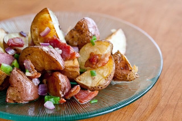 Bacon potato salad served on a glass plate 