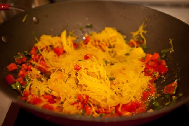 Cook spaghetti squash in the microwave - saute garlic, tomatoes, basil