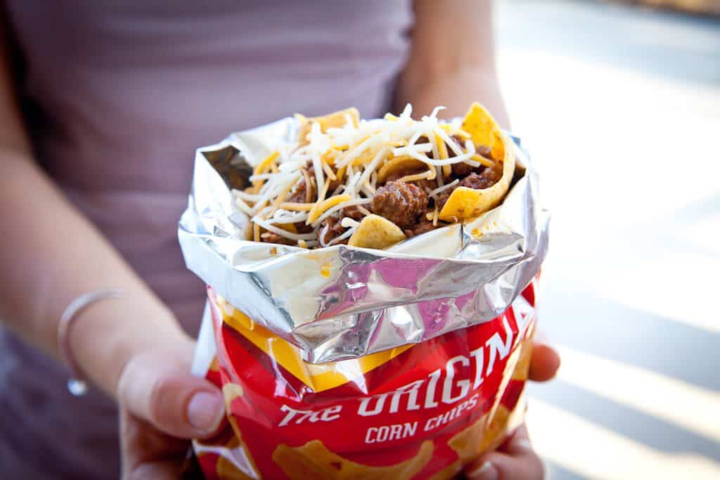 hand holding frito pie in bag