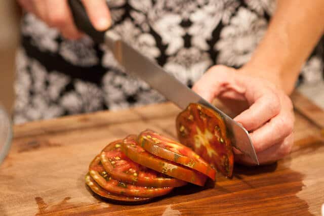 slicing tomatoes for Zucchini Frittata Recipe