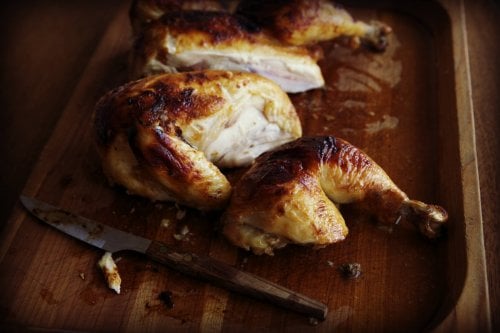 Miso roast chicken cut into pieces on a chopping board