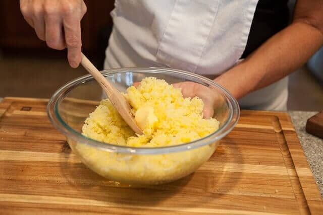 mix potatoes by hand with butter