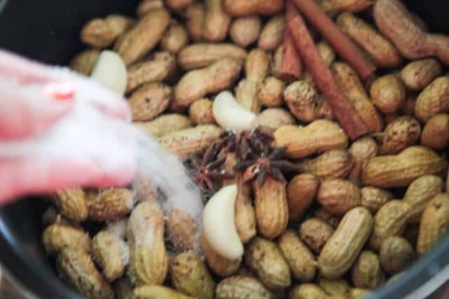 pouring spices and slat on peanuts