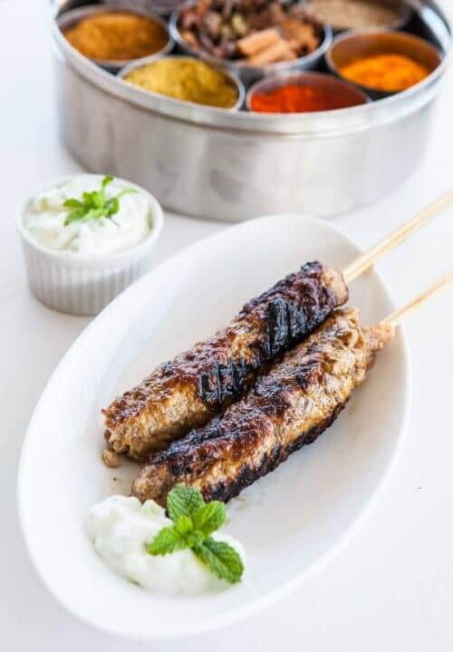 Grilled kebabs on a white plate
