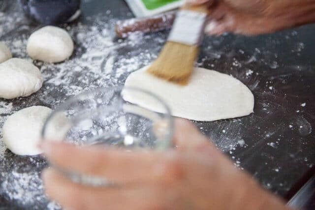 brushing oil on dough