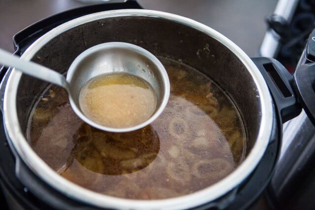 instant pot Ramen Recipe - darker broth in ladle