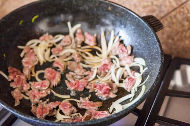  stir fry meat onion in pan