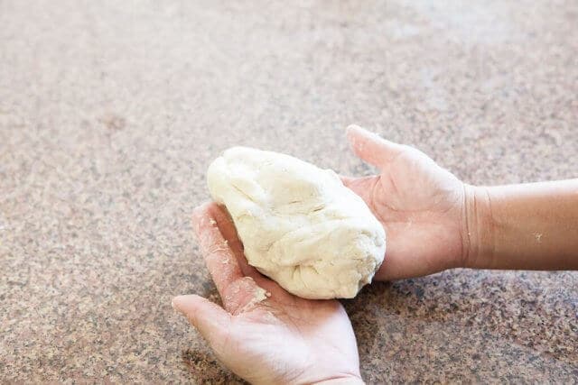 hands holding dough
