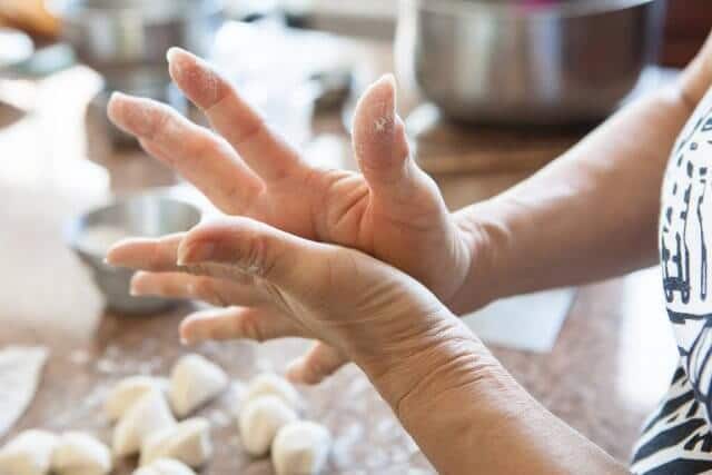 hands pressing dough