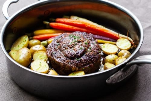 A one pan meal with carrots, potatoes and a ribeye steak