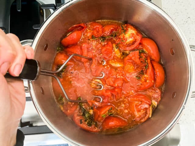Use a potato masher to make roasted tomato sauce recipe