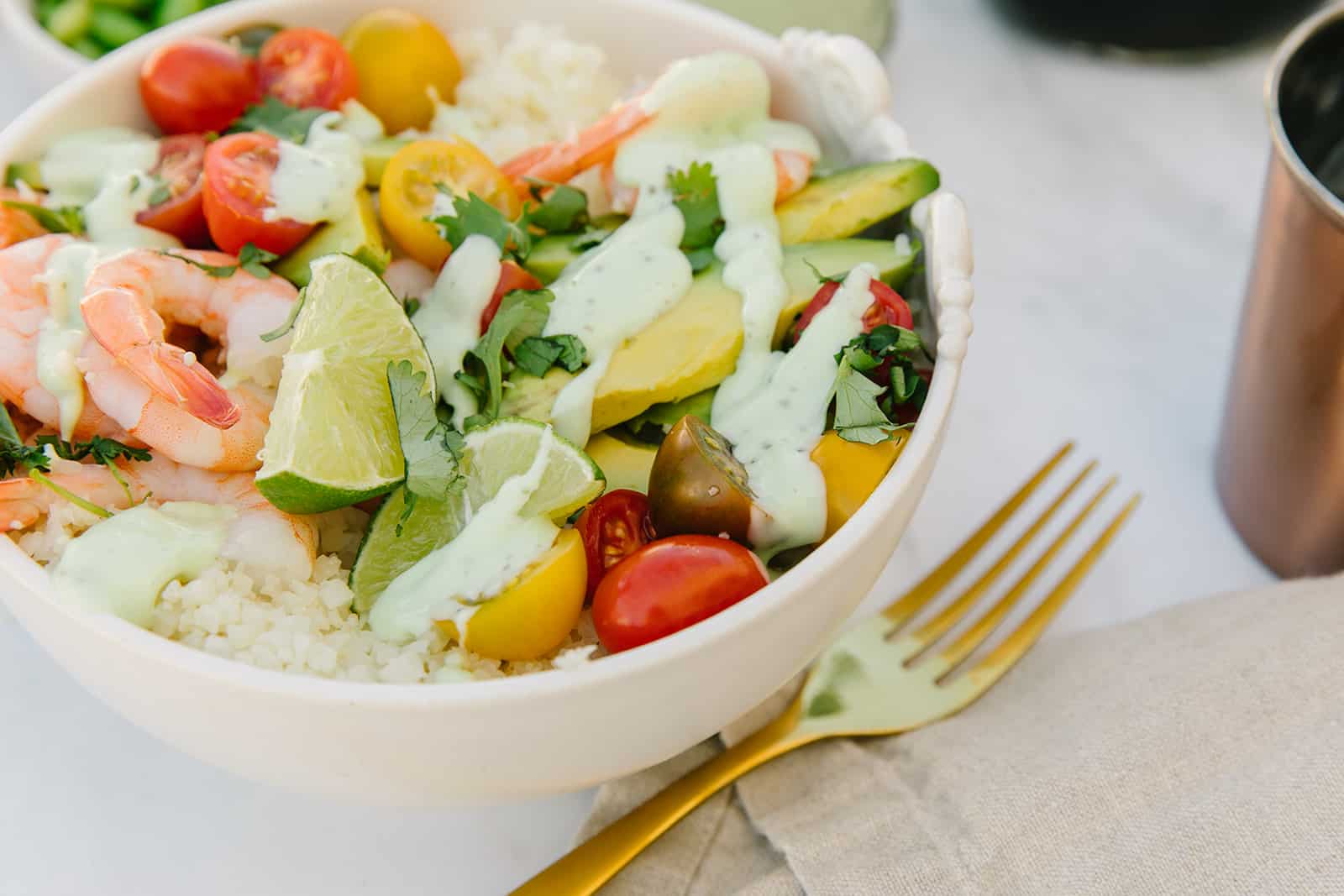 Shrimp avocado Buddha bowl with cilantro lime crema