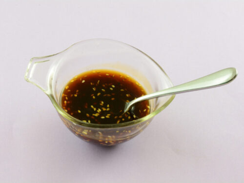 Teriyaki sauce in a glass jar with sesame seeds