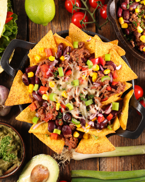 leftover brisket on top of tortilla chips in a skillet. 