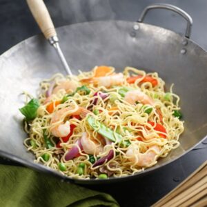 shrimp noodle dish in a wok.