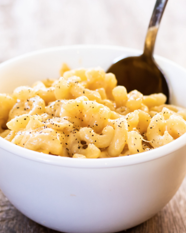 creamy mac and cheese in a white bowl.