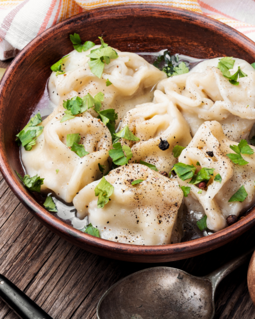 ground beef dumplings in a brown bowl with herbs. 