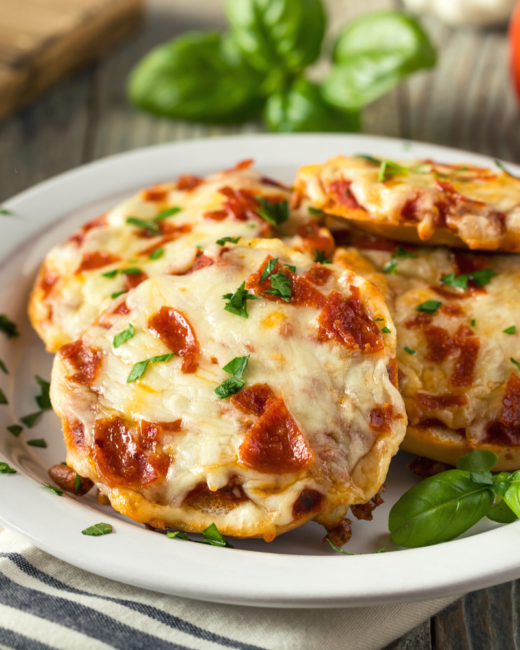 pizza bagel bites with pepperoni and fresh parsley.