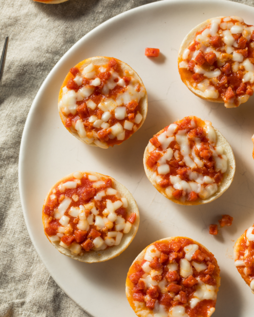 pepperoni pizza bagel bites on a white plate.