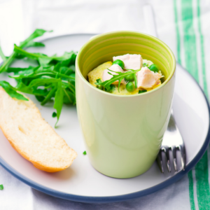microwave quiche with chicken and peas in green mug.