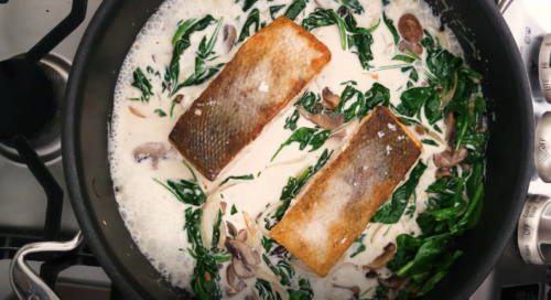Cooking salmon filets in a creamy mushroom sauce made with spinach, onions, heavy cream, and white wine. 