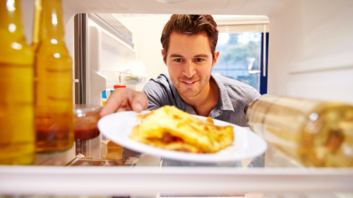 man pulling out leftovers