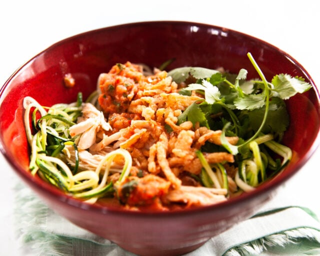 Salad chicken bowl with charred tomato salsa in red bowl