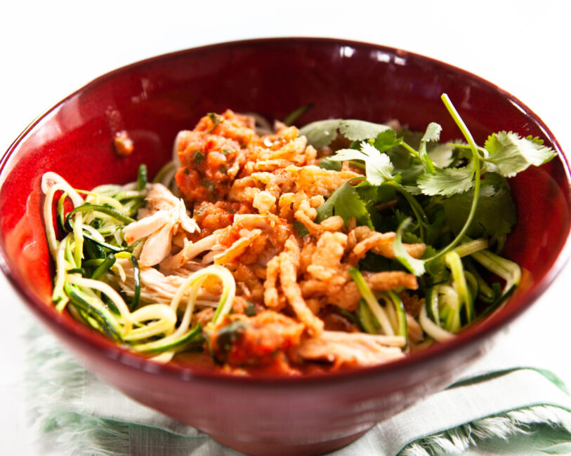 Salad chicken bowl with charred tomato salsa in red bowl