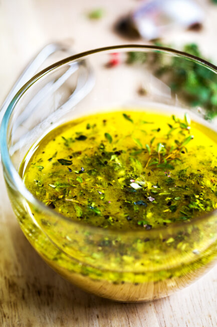 Greek Dressing with herbs in glass bowl 