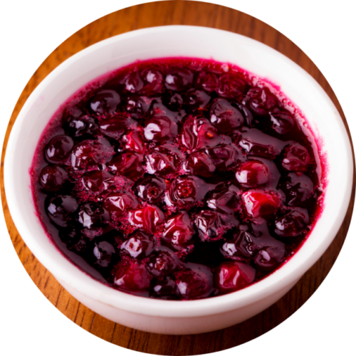 A white bowl of cranberry sauce