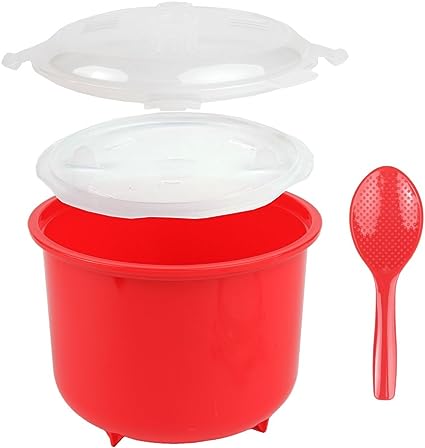 Bright red microwave rice cooker with clear and white vented lids, accompanied by a matching red perforated serving spoon.