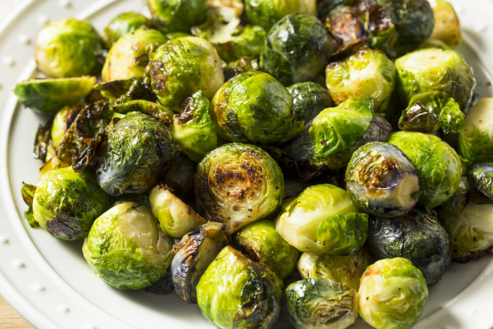 Sauteed Brussel Sprouts charred and on white plate