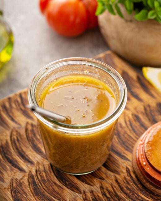 Smoky Sofrito Vinaigrette in mason jar and wooden background