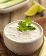 Blue Cheese Dressing in a small dish with fresh herbs and lime