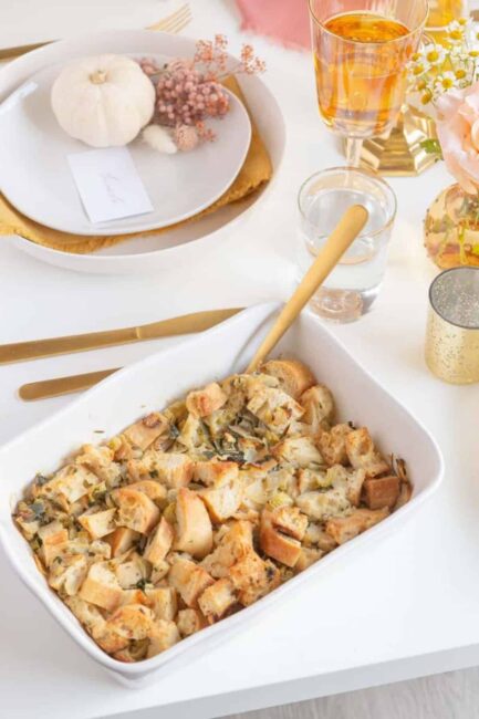 A white casserole dish with delicious bread stuffing inside.