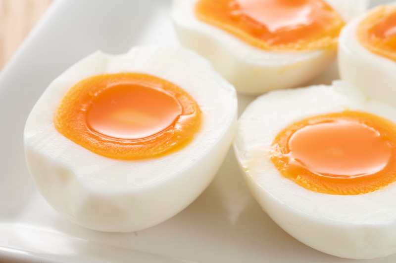 Soft-boiled eggs on white plate