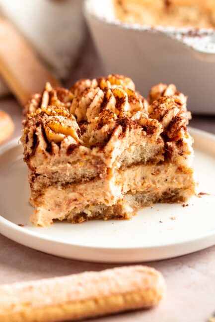 This pumpkin tiramisu is made with pumpkin mascarpone cream, layers of ladyfingers soaked in coffee, and topped with cocoa powder.