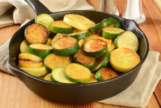 Zucchini and summer squash stir fried in a cast iron skillet