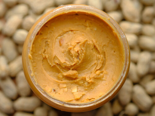 A top-down shot of peanut butter in a jar