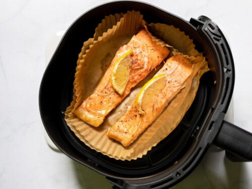 Salmon with lemon on parchment liner in air fryer