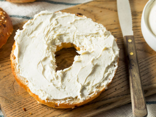 Half a bagel with cream cheese on top