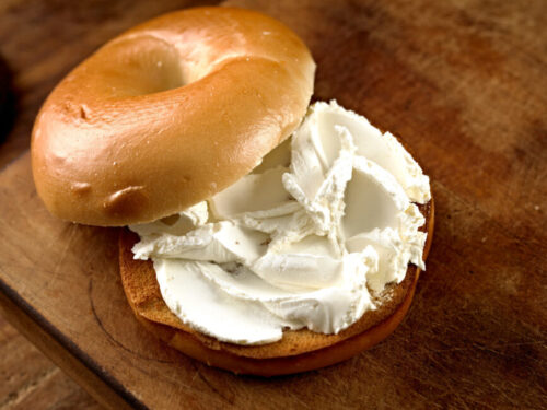 Cream cheese spread onto a bagel