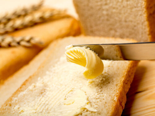 Spreading butter on toast with a butter knife